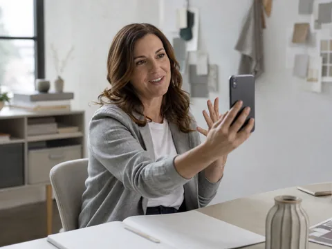 Customer recording a short video testimonial on a smartphone